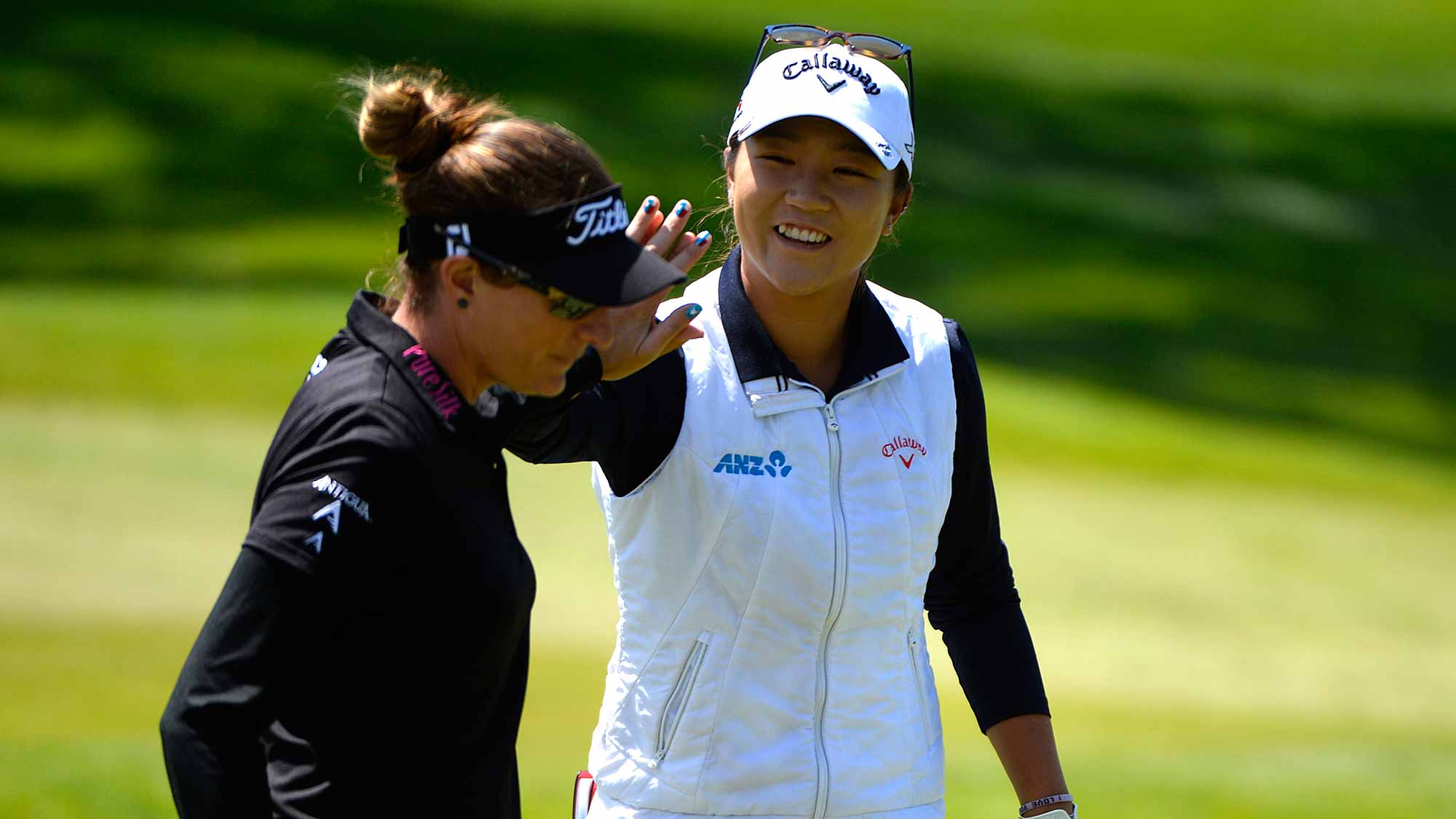 Lydia Ko of New Zealand celebrates a chip shot for a birdie on the fourth hole with Brittany Lang during round three of the Swinging Skirts LPGA Classic presented by CTBC at the Lake Merced Golf Club 