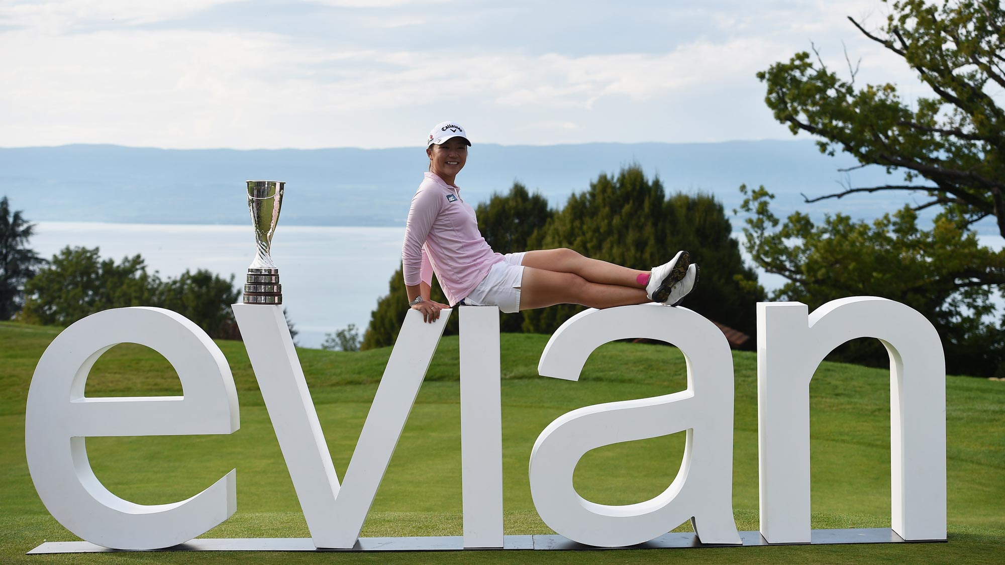 Lydia Ko poses with the giant Evian sign and her new Evian Championship Trophy after winning her first career major