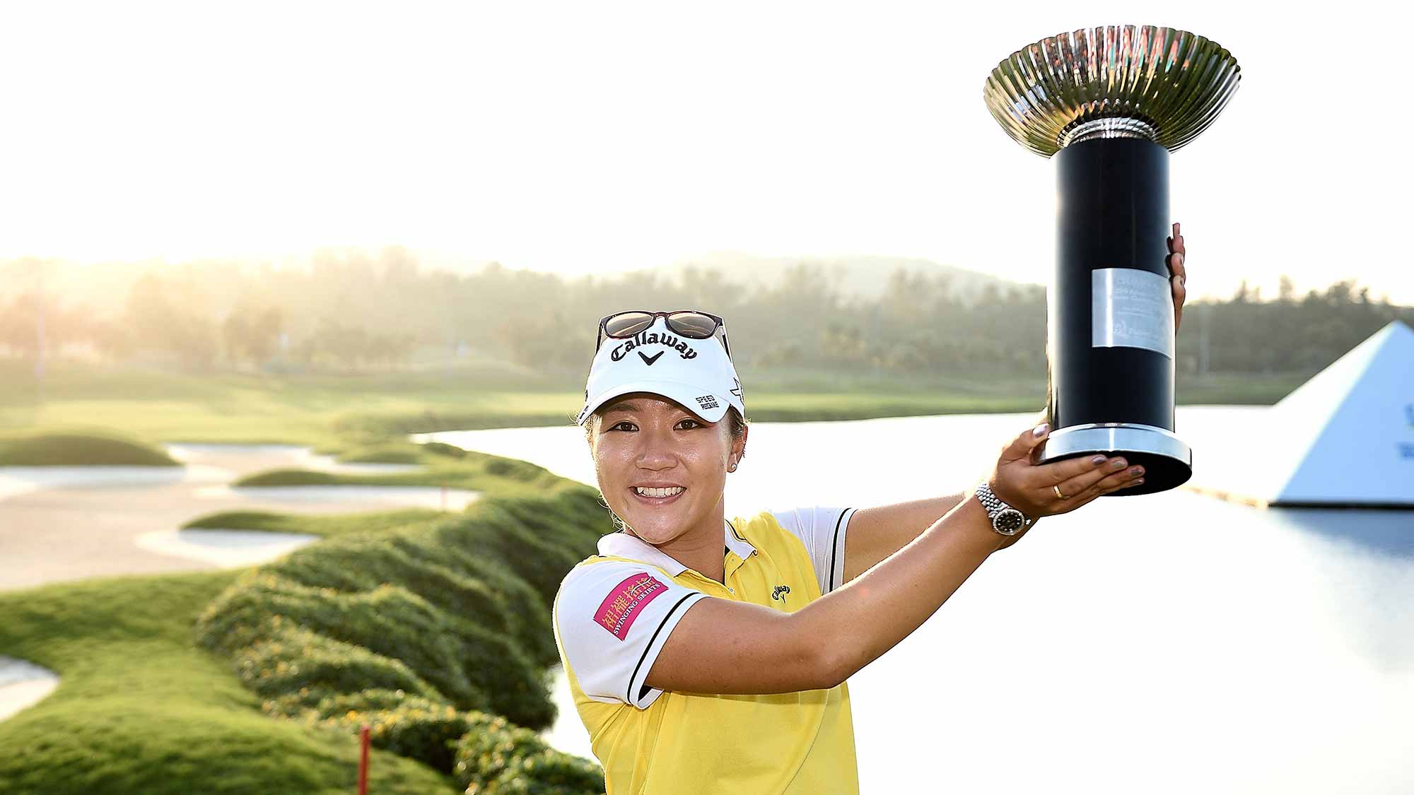 Lydia Ko poses with the trophy on the 18th green after winning 2015 Fubon LPGA Taiwan Championship on October 25, 2015 in Miramar Resort & Country Club